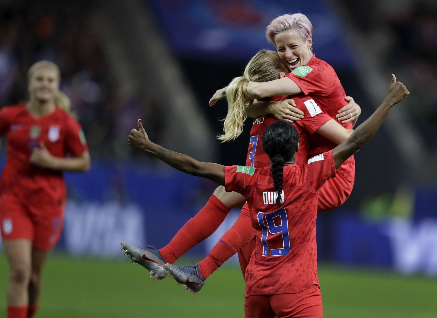 United States' scorer Samantha Mewis lifts her teammate Megan Rapinoe as she celebrates her side's 4rth goal during the Women's World Cup Group F soccer match between United States and Thailand at the Stade Auguste-Delaune in Reims, France, Tuesday, June 11, 2019. (AP Photo/Alessandra Tarantino)