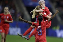 United States' scorer Samantha Mewis lifts her teammate Megan Rapinoe as she celebrates her side's 4rth goal during the Women's World Cup Group F soccer match between United States and Thailand at the Stade Auguste-Delaune in Reims, France, Tuesday, June 11, 2019. (AP Photo/Alessandra Tarantino)