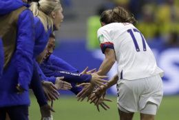 United States' Tobin Heath, right, celebrates with her teammates after their team's second goal during the Women's World Cup Group F soccer match between Sweden and the United States at Stade Océane, in Le Havre, France, Thursday, June 20, 2019. (AP Photo/Alessandra Tarantino)