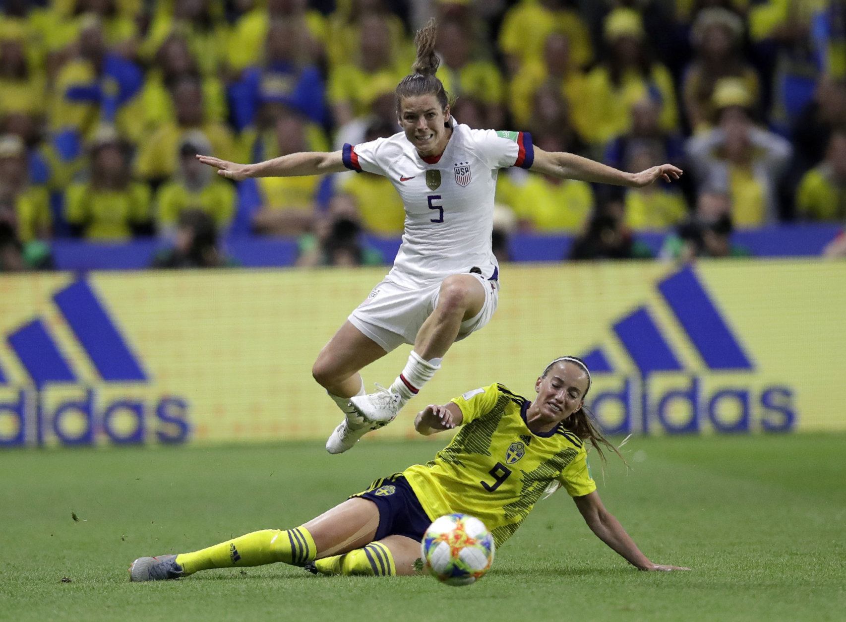 United States' Kelley O Hara leaps over Sweden's Kosovare Asllani during the Women's World Cup Group F soccer match between Sweden and the United States at Stade Océane, in Le Havre, France, Thursday, June 20, 2019. (AP Photo/Alessandra Tarantino)