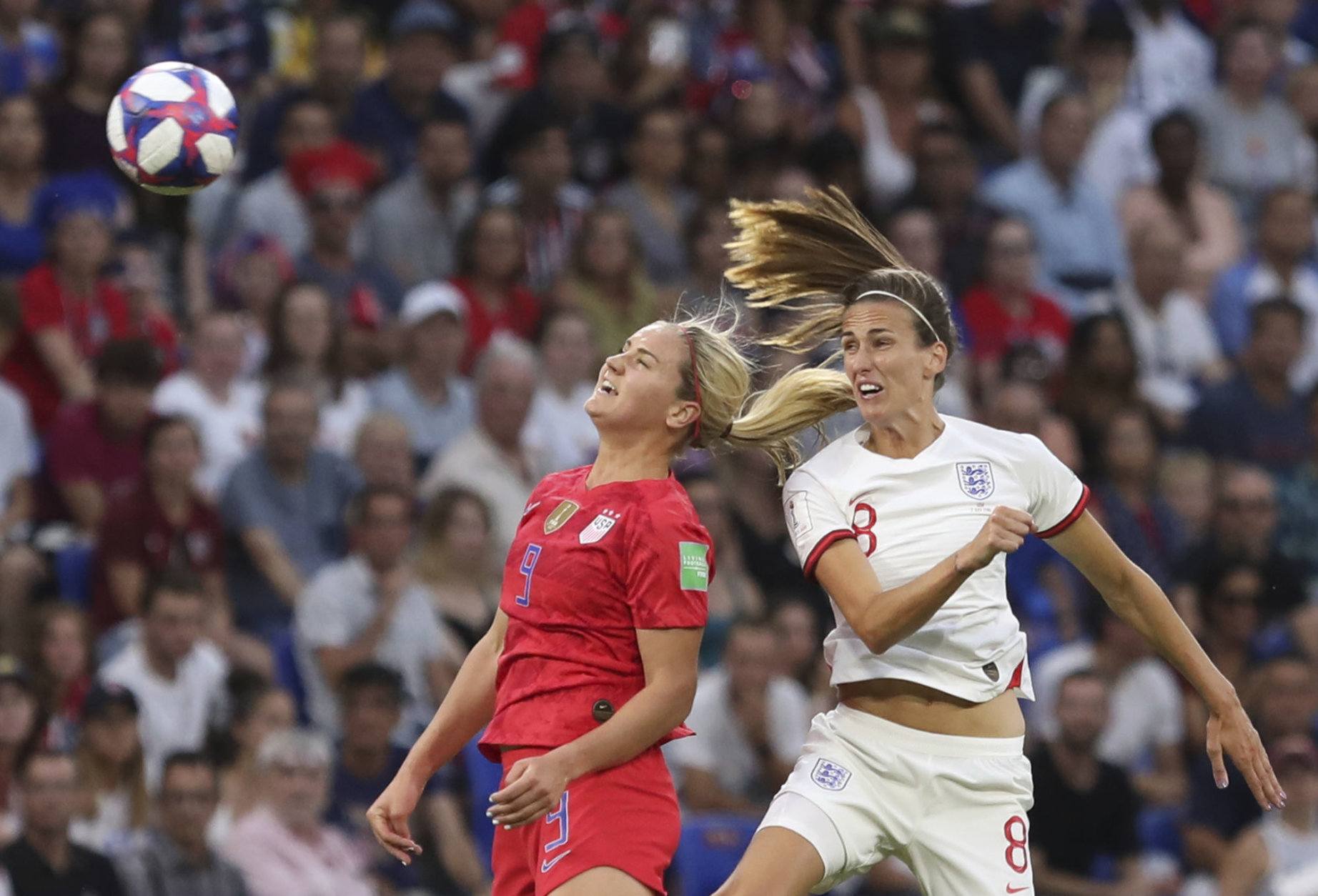 United States' Lindsey Horan, left, and England's Jill Scott challenge for the ball during the Women's World Cup semifinal soccer match between England and the United States, at the Stade de Lyon outside Lyon, France, Tuesday, July 2, 2019. (AP Photo/Laurent Cipriani)