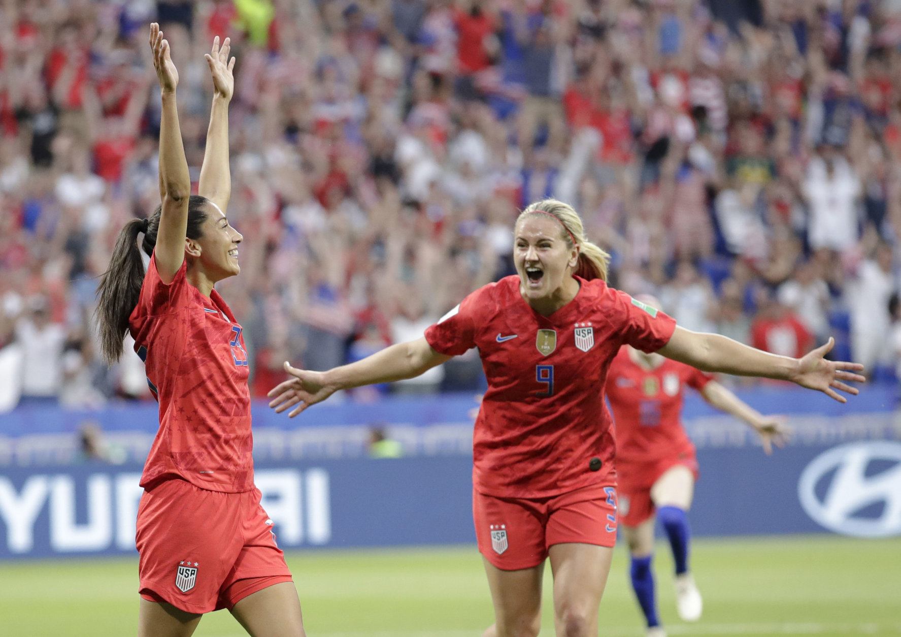 United States' Christen Press, left, celebrates after scoring her side's first goal during the Women's World Cup semifinal soccer match between England and the United States, at the Stade de Lyon, outside Lyon, France, Tuesday, July 2, 2019. (AP Photo/Alessandra Tarantino)
