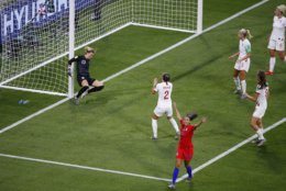 United States' Christen Press, bottom, reacts after scoring the opening goal of her team during the Women's World Cup semifinal soccer match between England and the United States, at the Stade de Lyon outside Lyon, France, Tuesday, July 2, 2019. (AP Photo/Francois Mori)
