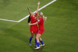 United States' Christen Press, left, reacts after scoring the opening goal of her team during the Women's World Cup semifinal soccer match between England and the United States, at the Stade de Lyon outside Lyon, France, Tuesday, July 2, 2019. (AP Photo/Francois Mori)