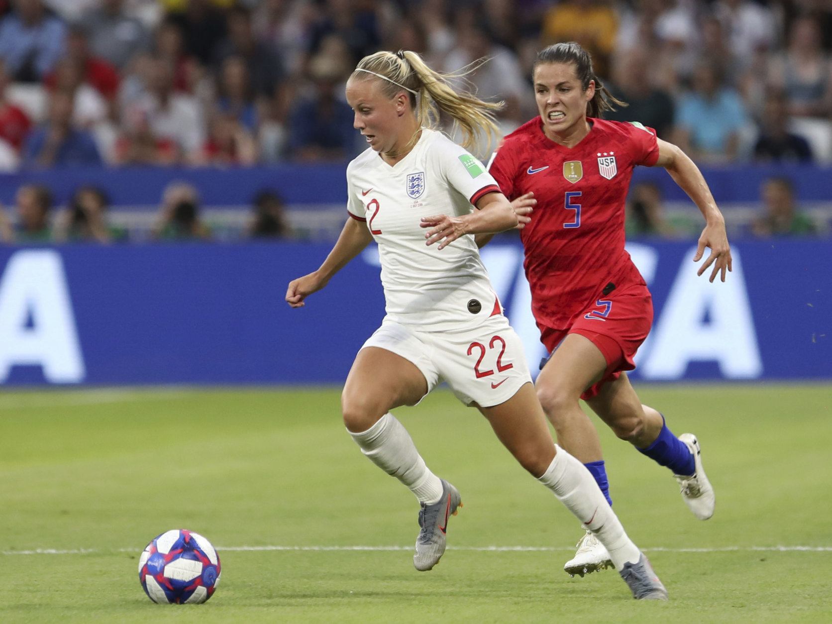 England's Beth Mead, left, and United States' Kelley O Hara challenge for the ball during the Women's World Cup semifinal soccer match between England and the United States, at the Stade de Lyon outside Lyon, France, Tuesday, July 2, 2019. (AP Photo/Laurent Cipriani)