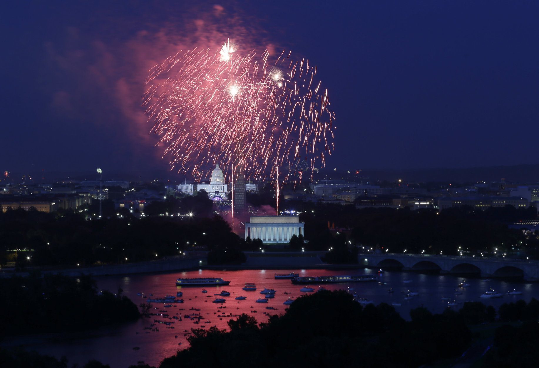 Fireworks light the sky over the U.S. Capitol, left, the Washington Monument and the Lincoln Memorial during Fourth of July celebrations, Thursday, July 4, 2013 in Washington. Surrounded by scaffolding, the Washington Monument is closed for repairs after an earthquake in 2011. (AP Photo/Alex Brandon)