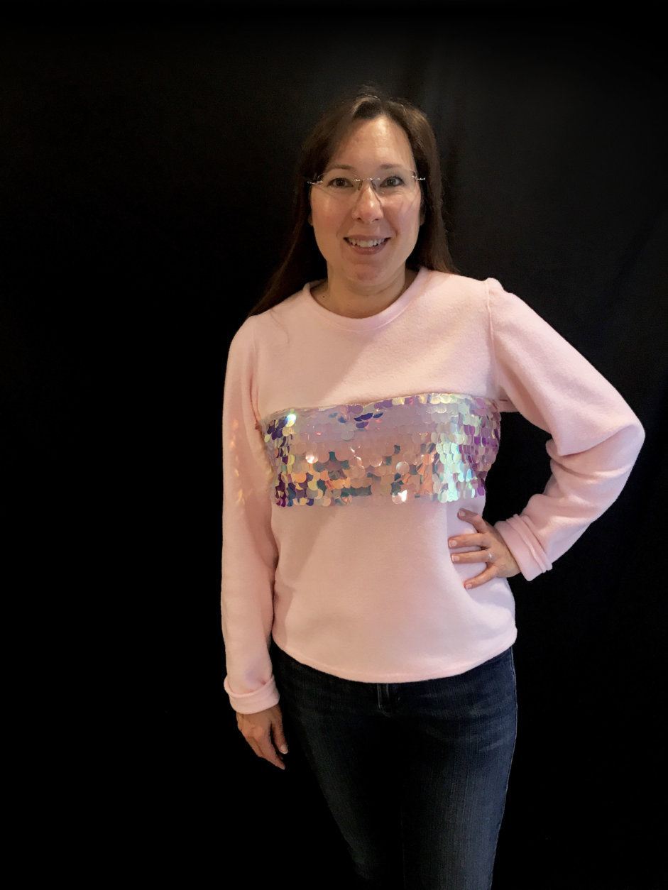 This is one of the items Christina designed for her site. It's a fleece pink sweatshirt with a sequin stripe through the middle. Her mom Nicole Mellott loved it so much, it's now her favorite shirt. (Courtesy Christina Mellott)