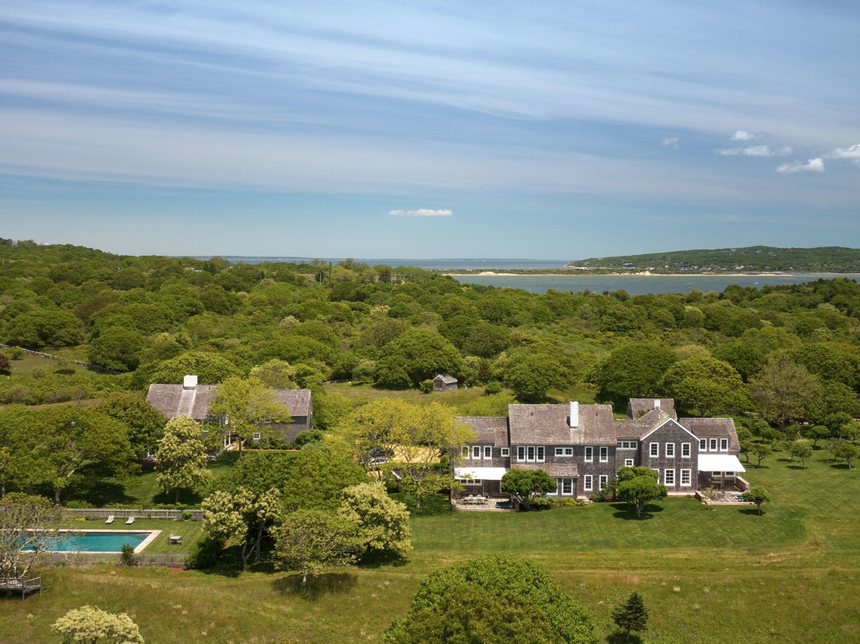 The 6,456-square-foot cedar-shingled main residence has five en-suite bedrooms, two half baths, a chef’s kitchen equipped with professional grade appliances, two offices or artist studios. Three fireplaces warm the home, and outdoor decks drink in the serene water and nature views with the dunes in the distance. (Laura Moss Photography)