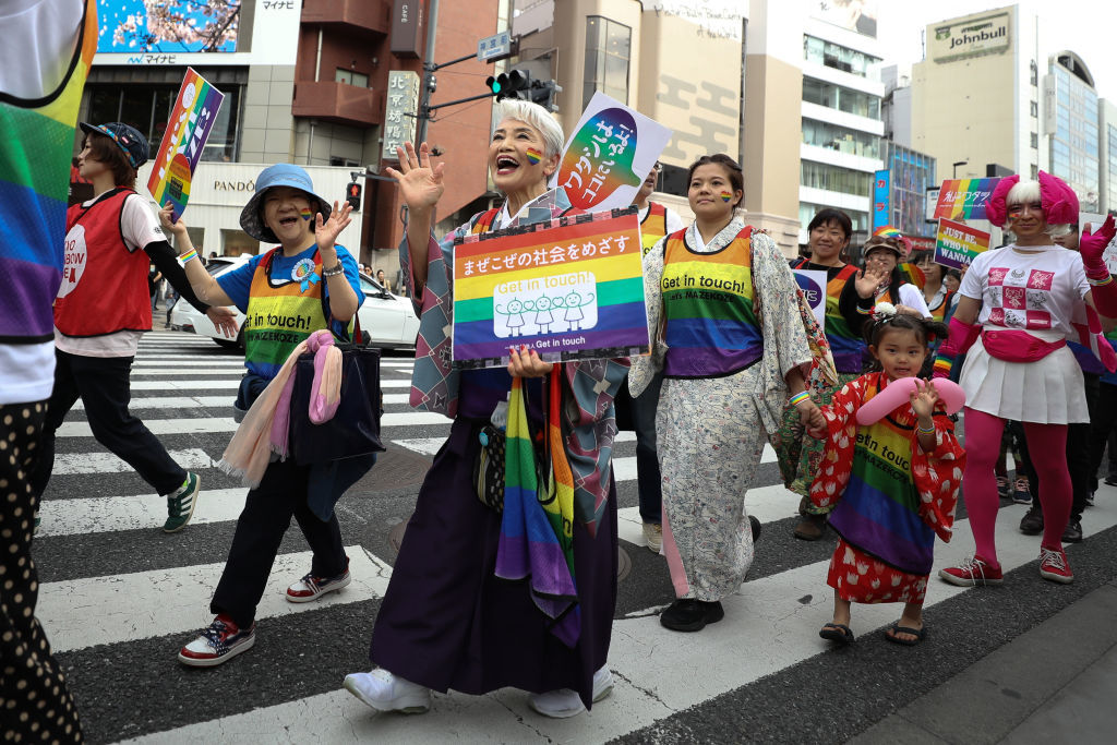 TOKYO, JAPAN - APRIL 28: Participants walk down the street during the Tokyo Rainbow Pride Parade on April 28, 2019 in Tokyo, Japan. Thousands from the Japanese LGBT community and its supporters are expected to attend the annual Tokyo Rainbow Pride festival on April 28-29 in Yoyogi Park, with the Parade taking place on April 28th. The festival takes place during pride week, which runs through to May 6.  (Photo by Takashi Aoyama/Getty Images)