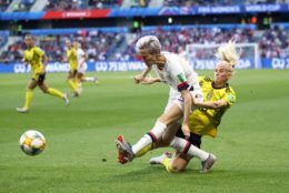 LE HAVRE, FRANCE - JUNE 20: Megan Rapinoe of the USA is challenged by Sofia Jakobsson of Sweden during the 2019 FIFA Women's World Cup France group F match between Sweden and USA at Stade Oceane on June 20, 2019 in Le Havre, France. (Photo by Alex Grimm/Getty Images)