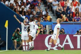 PARIS, FRANCE - JUNE 28:  Megan Rapinoe of the USA celebrates with teammates after scoring her team's first goal during the 2019 FIFA Women's World Cup France Quarter Final match between France and USA at Parc des Princes on June 28, 2019 in Paris, France. (Photo by Richard Heathcote/Getty Images)