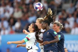 PARIS, FRANCE - JUNE 28:  Alex Morgan of the USA jumps for the ball with Griedge Mbock Bathy of France during the 2019 FIFA Women's World Cup France Quarter Final match between France and USA at Parc des Princes on June 28, 2019 in Paris, France. (Photo by Alex Grimm/Getty Images)