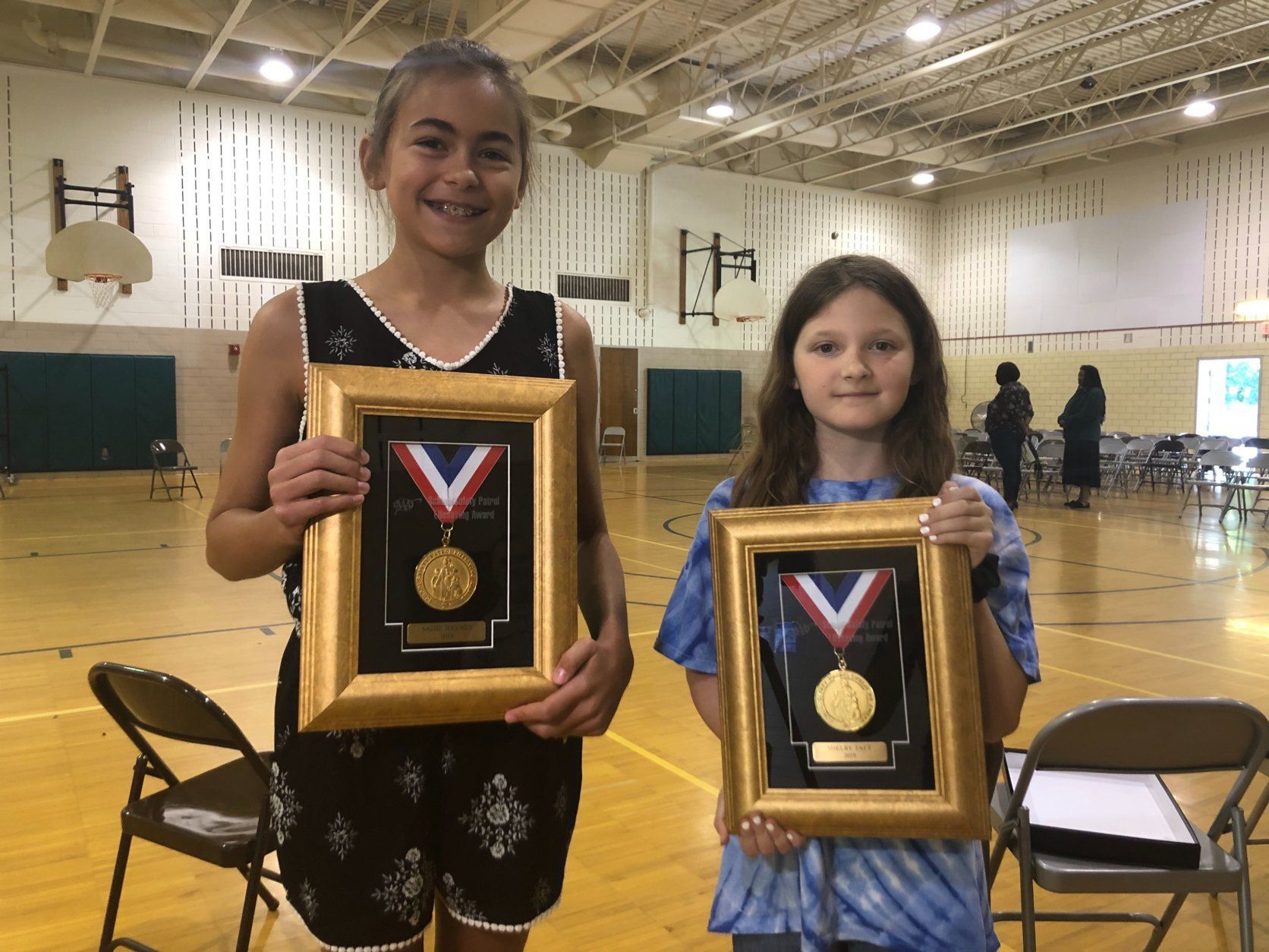 Sadie Haynes, left, and Shelby Taft pose with their Lifesaving Medals, presented by AAA, on Tuesday, June 11, 2019 in Silver Spring, Maryland. (WTOP/Melissa Howell)
