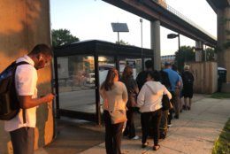 Metro riders wait for a shuttle to arrive June 3, 2019. (WTOP/Melissa Howell)