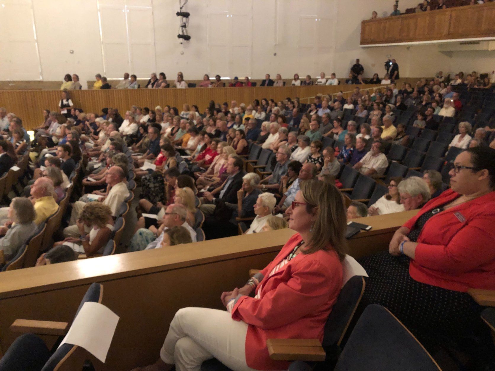 Family, friends and community members packed into the Maryland Hall in Annapolis Friday night to remember the five Capital Gazette employees who died after a gunman opened fire in their newsroom exactly one year ago. (WTOP/Mike Murillo)