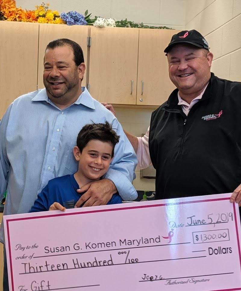 From left, Aaron Goldberg, son Joey, and Michael Jessup of the Susan G. Komen Foundation, gather at Beverly Farms Elementary to surprise Joey who raised $1,300 for cancer research. (Courtesy Aaron Goldberg)