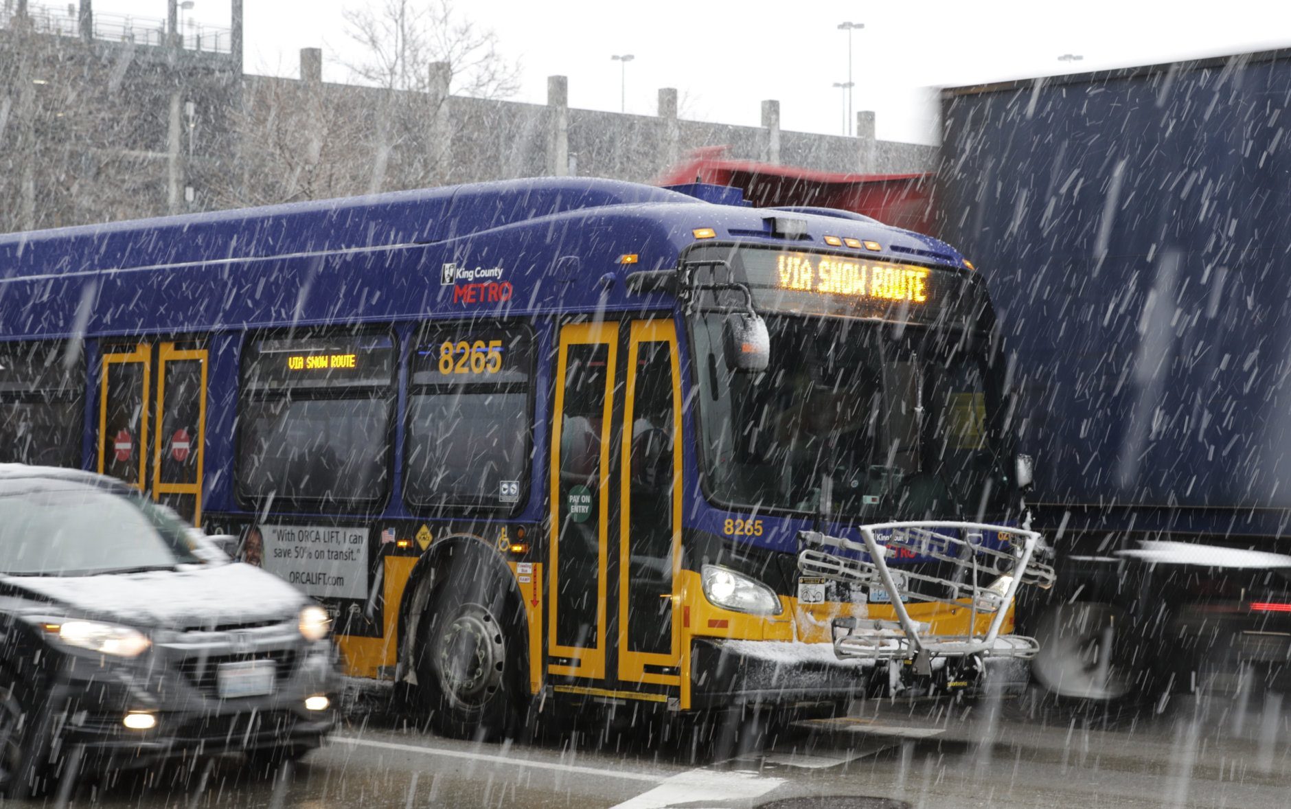 A King County Metro bus displays a snow route sign, Monday, Feb. 11, 2019, in Seattle. Schools were closed across Washington state as winter snowstorms continued pummeling the Northwest. Seattle's metro area has already been hit by three snowstorms in February, making it the snowiest month in Seattle in more than 30 years. (AP Photo/Ted S. Warren)
