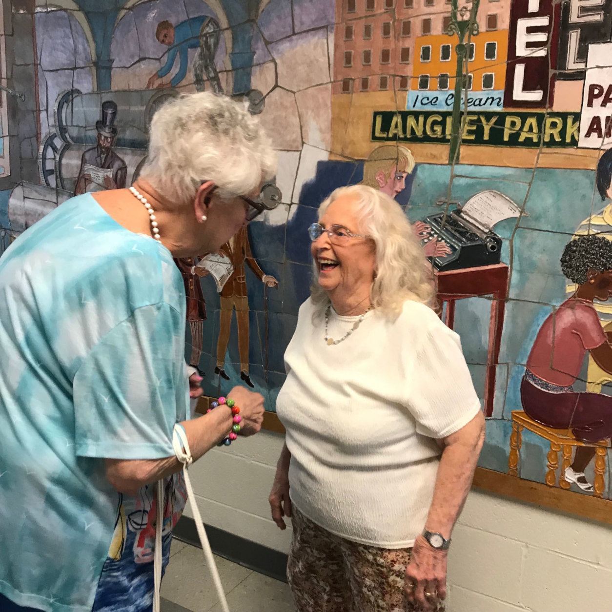 Former New Hampshire Estates Elementary School principal Joanne Busalacchi bids goodbye to teacher's aide Ginny Bumblis, who retires after 50 years of teaching. (WTOP/Dick Uliano)