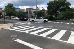The new ladder crosswalks consist of a more-reflective material. And with more of that paint on the road, it "pops out," said DDOT Director Jeff Marootian. (WTOP/Kristi King)