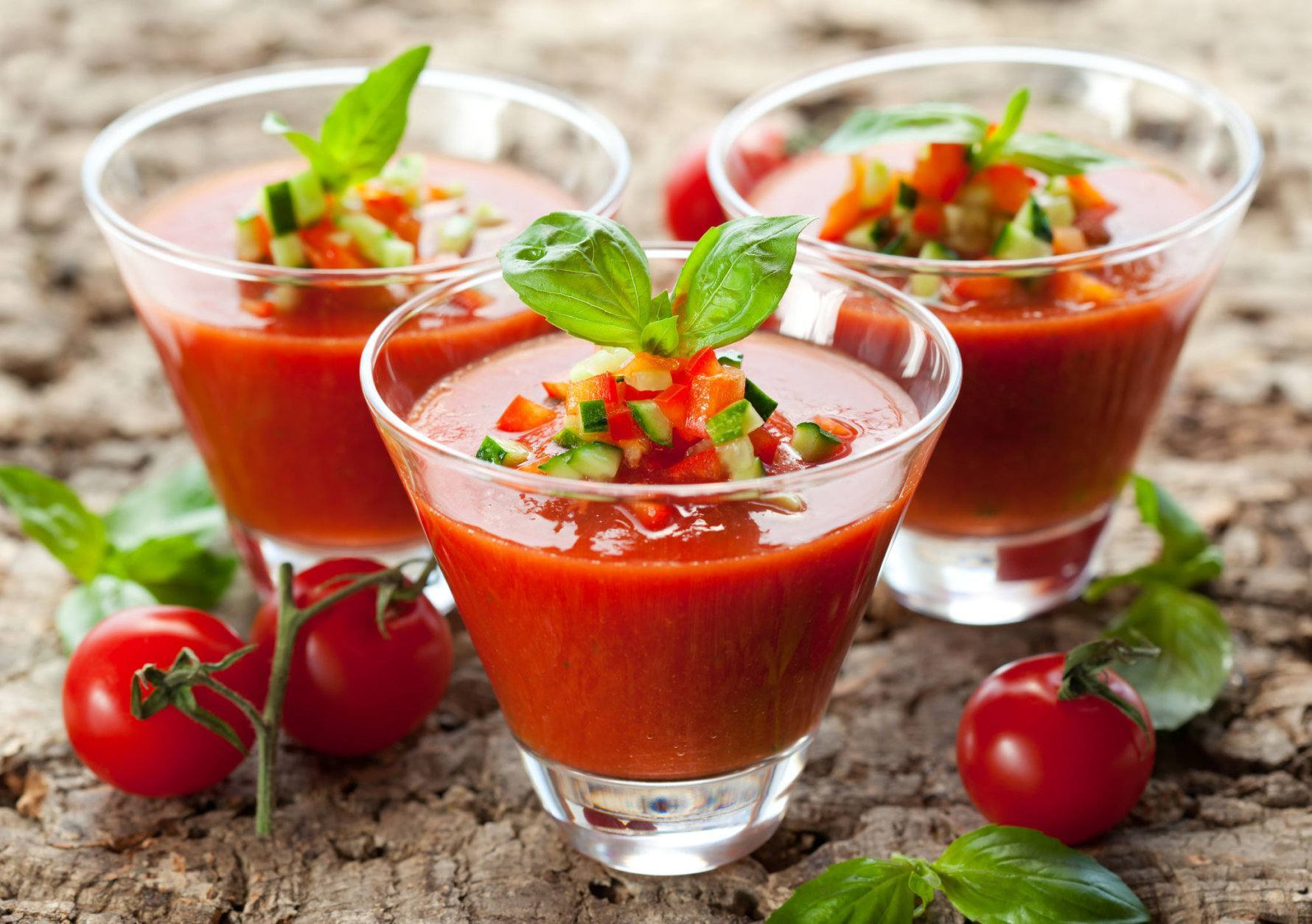 delicious cold Gazpacho soup in glasses on the wooden table