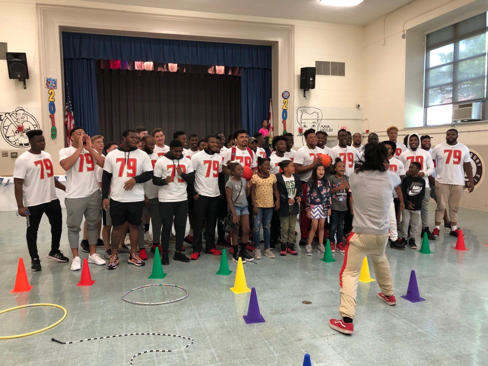 University of Maryland football players cheer with students at J.C. Nalle Elementary to celebrate Jordan McNair. (WTOP/Michelle Basch)