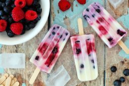 Group of homemade mixed berry yogurt popsicles on a rustic wood background (Getty Images/iStockphoto)