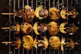 Vegetarian skewers with potatoes, mushrooms and onions in a herb dressing on grill pan