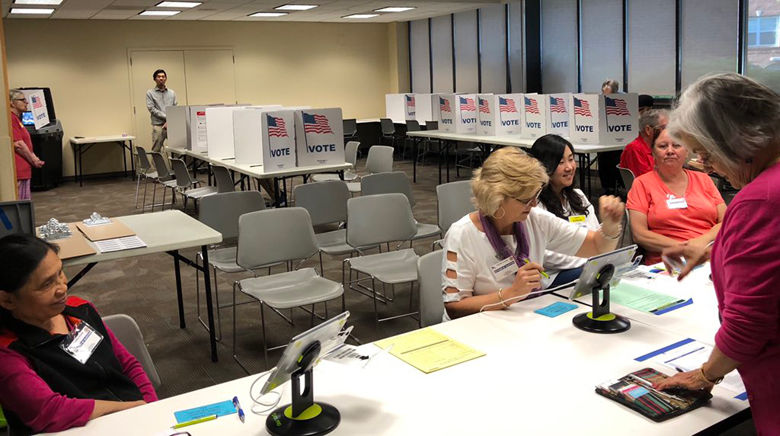 Volunteers were busy at the Reston precinct 223 even though turnout was low.  They had a lot of absentee ballots. (WTOP/Kristi King)