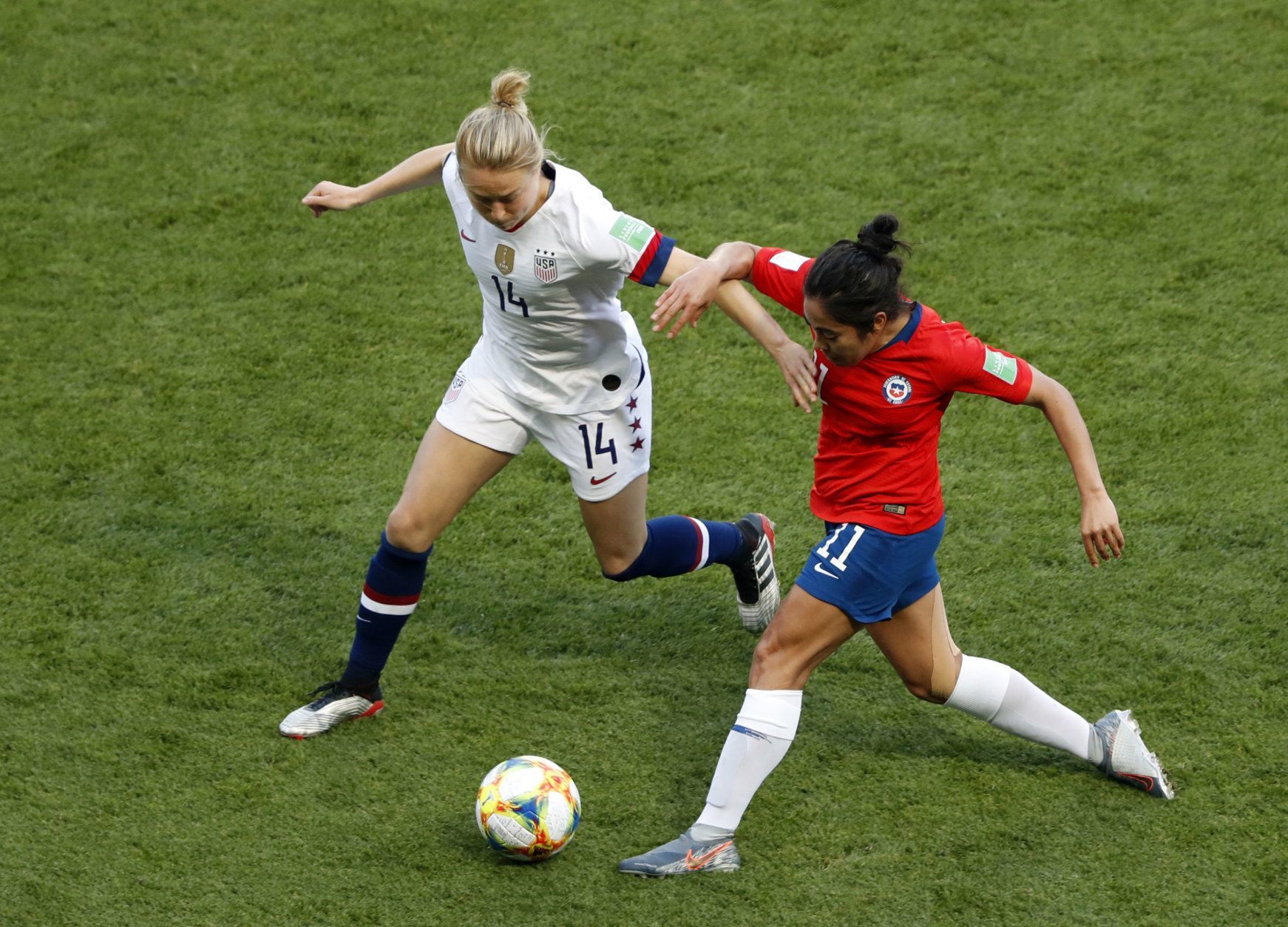 United States' Emily Sonnett vies for the ball with Chile's Yessenia Lopez, right, during the Women's World Cup Group F soccer match between the United States and Chile at the Parc des Princes in Paris, Sunday, June 16, 2019. (AP Photo/Thibault Camus)