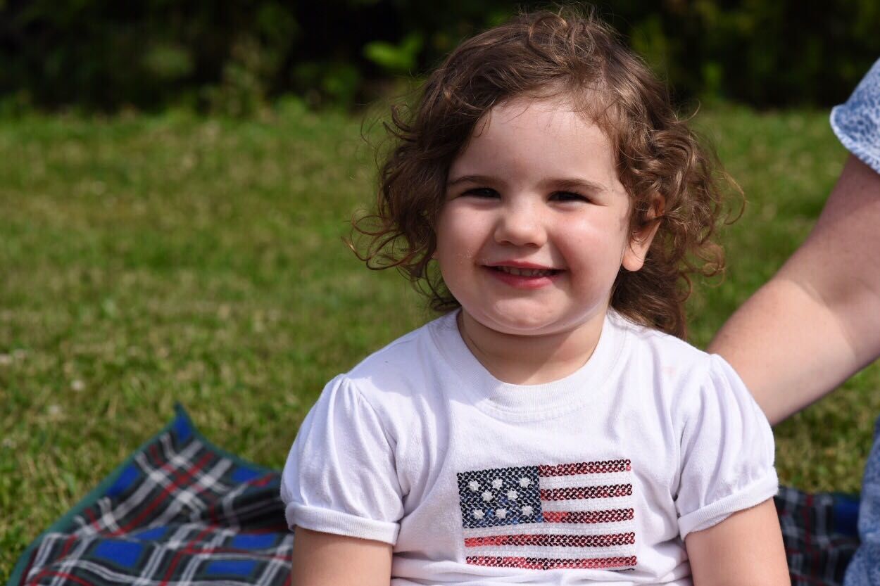 Reese Lewis, River’s older sister, waits for the Takoma Park Fourth of July parade. (WTOP/Kate Ryan)