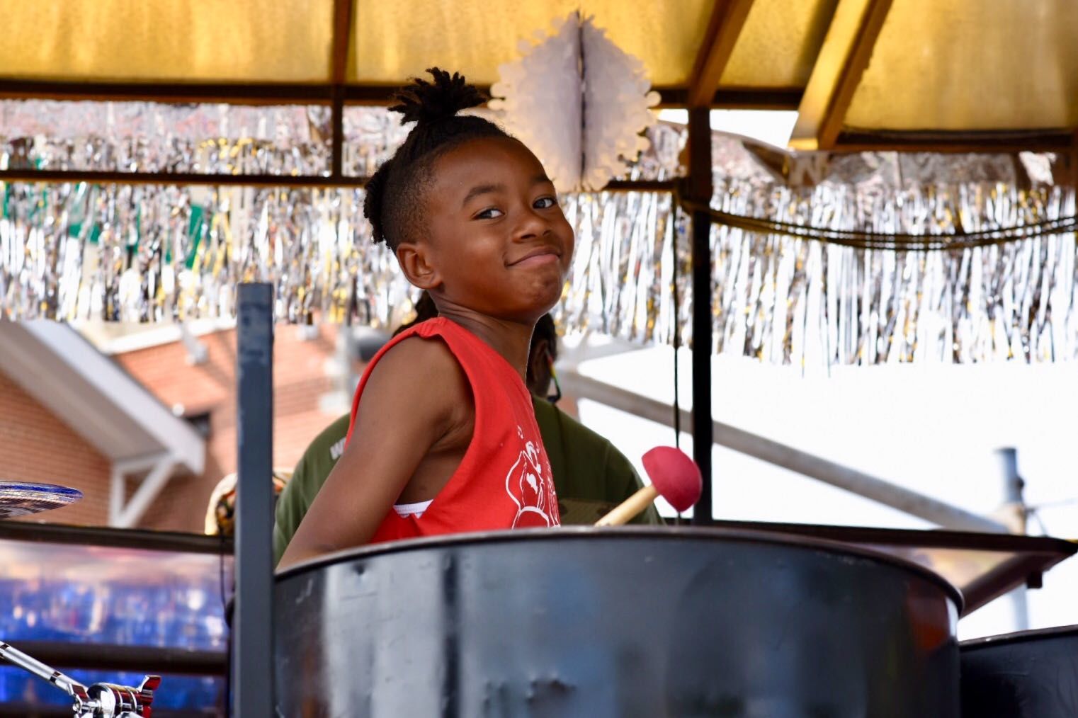 A member of the Panquilty Steel Drum unit in the Takoma Park Parade. (WTOP/Kate Ryan)