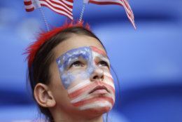 A United States fan with a painted face waits for the start of the Women's World Cup semifinal soccer match between England and the United States, at the Stade de Lyon outside Lyon, France, Tuesday, July 2, 2019. (AP Photo/Alessandra Tarantino)