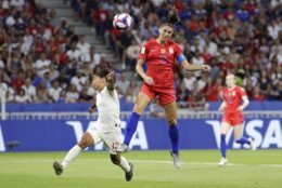 United States' Alex Morgan, right, scores her side's second goal, during the Women's World Cup semifinal soccer match between England and the United States, at the Stade de Lyon, outside Lyon, France, Tuesday, July 2, 2019. (AP Photo/Alessandra Tarantino)