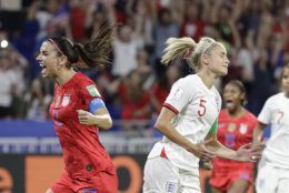 England's Steph Houghton, right, grimaces after failing to score from the penalty spot as United States' Alex Morgan celebrates during the Women's World Cup semifinal soccer match between England and the United States, at the Stade de Lyon, outside Lyon, France, Tuesday, July 2, 2019. (AP Photo/Alessandra Tarantino)