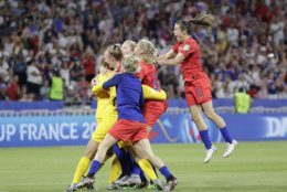 United States' players celebrate at the end of the Women's World Cup semifinal soccer match between England and the United States, at the Stade de Lyon, outside Lyon, France, Tuesday, July 2, 2019. (AP Photo/Alessandra Tarantino)