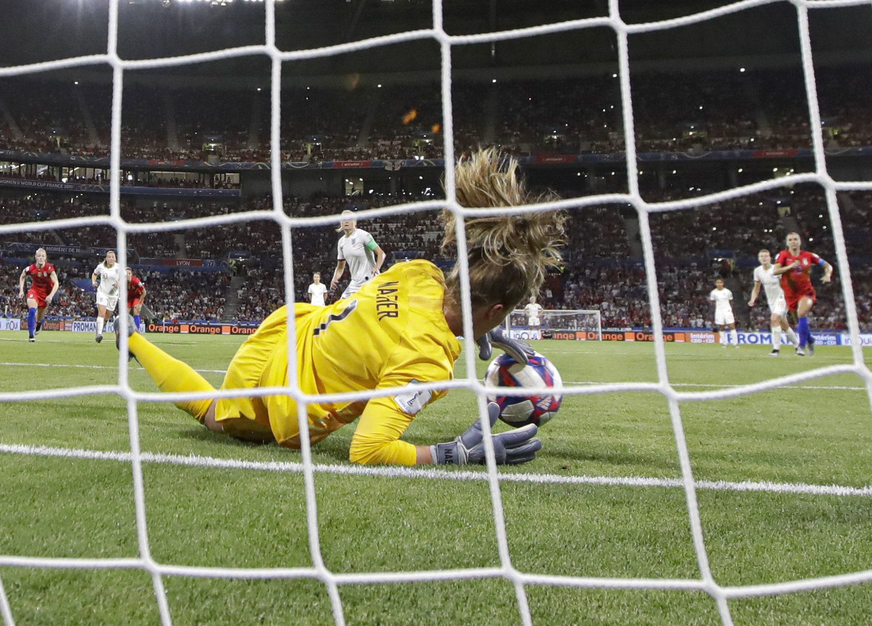 United States goalkeeper Alyssa Naeher saves a penalty shot taken by England's Steph Houghton during the Women's World Cup semifinal soccer match between England and the United States, at the Stade de Lyon, outside Lyon, France, Tuesday, July 2, 2019. (AP Photo/Alessandra Tarantino)