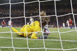 United States goalkeeper Alyssa Naeher saves a penalty shot taken by England's Steph Houghton during the Women's World Cup semifinal soccer match between England and the United States, at the Stade de Lyon, outside Lyon, France, Tuesday, July 2, 2019. (AP Photo/Alessandra Tarantino)
