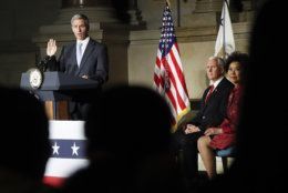 Acting Director, US Immigration and Immigration Services, Kenneth T. Cuccinelli, left, administers the Oath of Allegiance during a naturalization ceremony in celebration of Independence Day at the National Archives in Washington, Thursday, July 4, 2019. Also on stage are Vice President Mike Pence and Secretary of Transportation Elaine Chao, far right. (AP Photo/Pablo Martinez Monsivais)