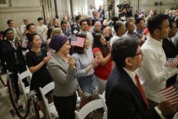 People begin celebrate after taking the Oath of Allegiance during a naturalization ceremony in celebration of Independence Day at the National Archives in Washington, Thursday, July 4, 2019. (AP Photo/Pablo Martinez Monsivais)
