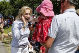 Democratic presidential candidate Sen. Kirsten Gillibrand, D-N.Y., gives a high-five to a child along the route during the Fourth of July Parade, Thursday, July 4, 2019, in Amherst. (AP Photo/Mary Schwalm)