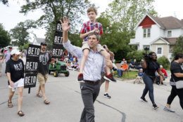 Democratic presidential candidate former Texas Congressman Beto O'Rourke carries his son Henry on his shoulders as he walks in the Independence Fourth of July parade, Thursday, July 4, 2019, in Independence, Iowa. (AP Photo/Charlie Neibergall)