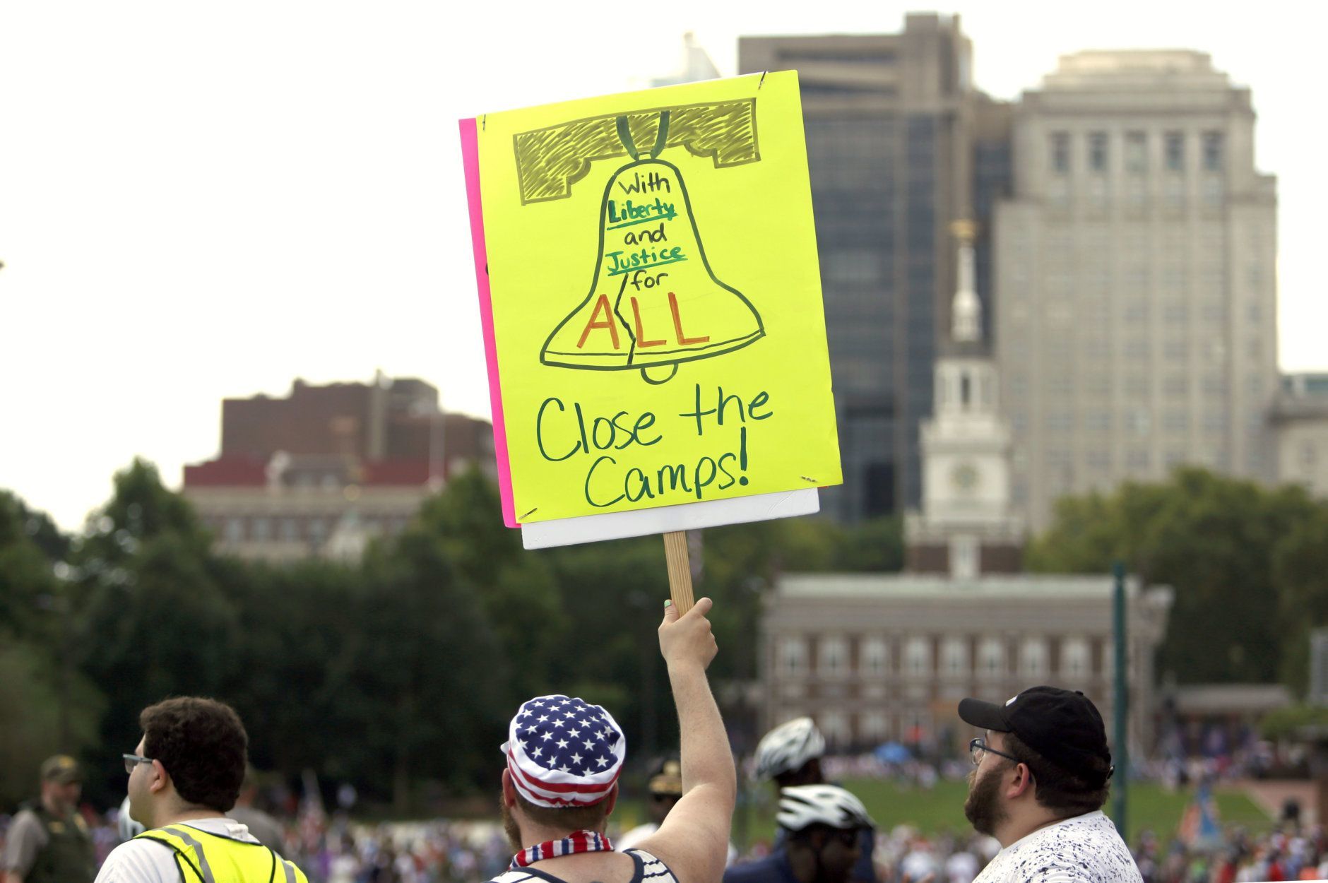 Protestors assembled by a majority Jewish group called "Never Again Is Now" demonstrate near Independence Hall, background, Thursday July 4, 2019, in Philadelphia. Hundreds gathered during the city's traditional Fourth of July parade to protest the treatment of immigrants and asylum seekers. (AP Photo/Jacqueline Larma)