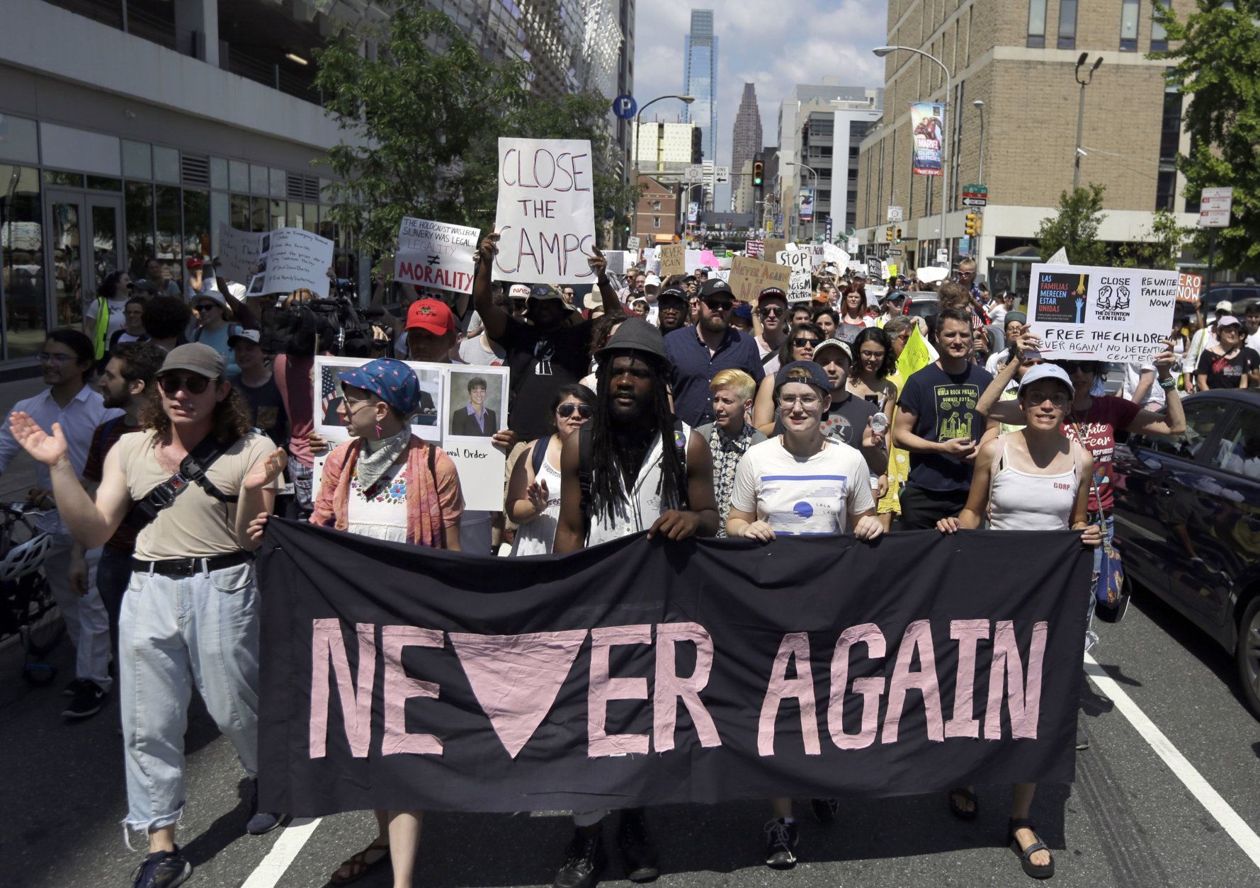 Protestors assembled by a majority Jewish group called "Never Again Is Now" walk through traffic as they make their way to Independence Mall Thursday July 4, 2019, in Philadelphia. Hundreds gathered during the city's traditional Fourth of July parade to protest the treatment of immigrants and asylum seekers. (AP Photo/Jacqueline Larma)