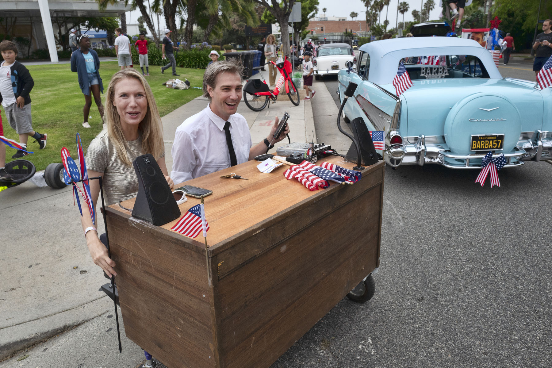 Gray Bright, and Kyle McAuley arrive to participate in the Fourth of July parade with their motorized "Late Nite" desk to conduct interviews with scientists and tech people on Thursday, July 4, 2019 in Santa Monica, Calif. (AP Photo/Richard Vogel)