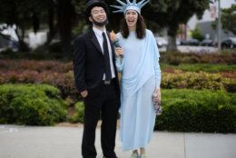 Christian Tomita, left and Erin Wells arrive dressed as Abraham Lincoln and Lady Liberty to participate in the Santa Monica Fourth of July parade Thursday, July 4, 2019 in Santa Monica, Calif. (AP Photo/Richard Vogel)