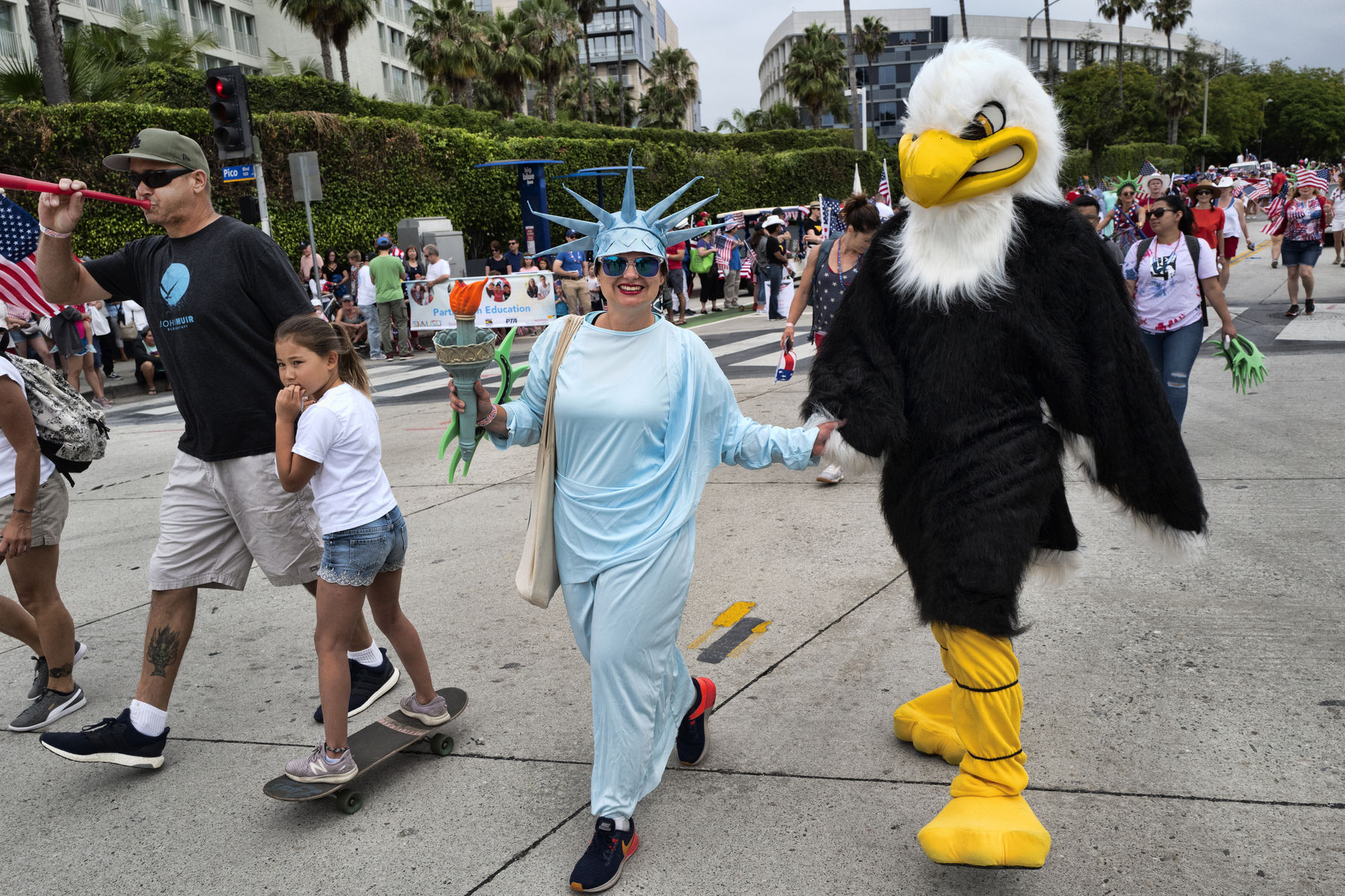 Dressed as Lady Liberty and the American Eagle participants parade down a street while joining in on the festivities at the Santa Monica Fourth of July parade, Thursday July 4, 2019 in Santa Monica, Calif. (AP Photo/Richard Vogel)