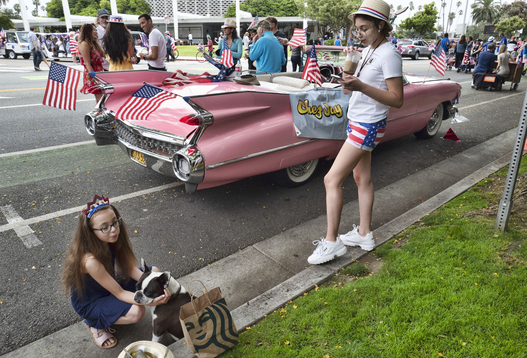 Classic cars and participants wait on the street to take part in the Fourth of July parade in Santa Monica, Calif., on Thursday, July 4, 2019. (AP Photo/Richard Vogel)