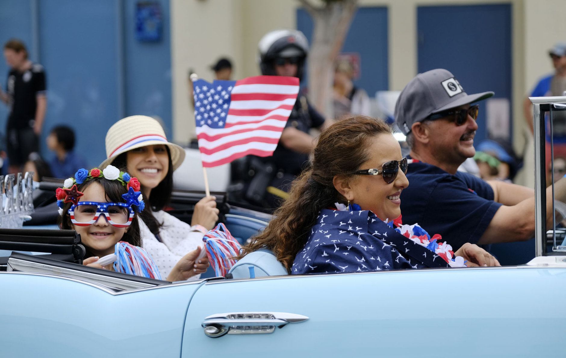 Sophie Barba, 8, left, joins her family in their classic car to celebrate the nation's birthday during the Santa Monica Fourth of July Parade in Santa Monica, Calif., on Thursday, July 4, 2019 in Santa Monica, Calif. (AP Photo/Richard Vogel)