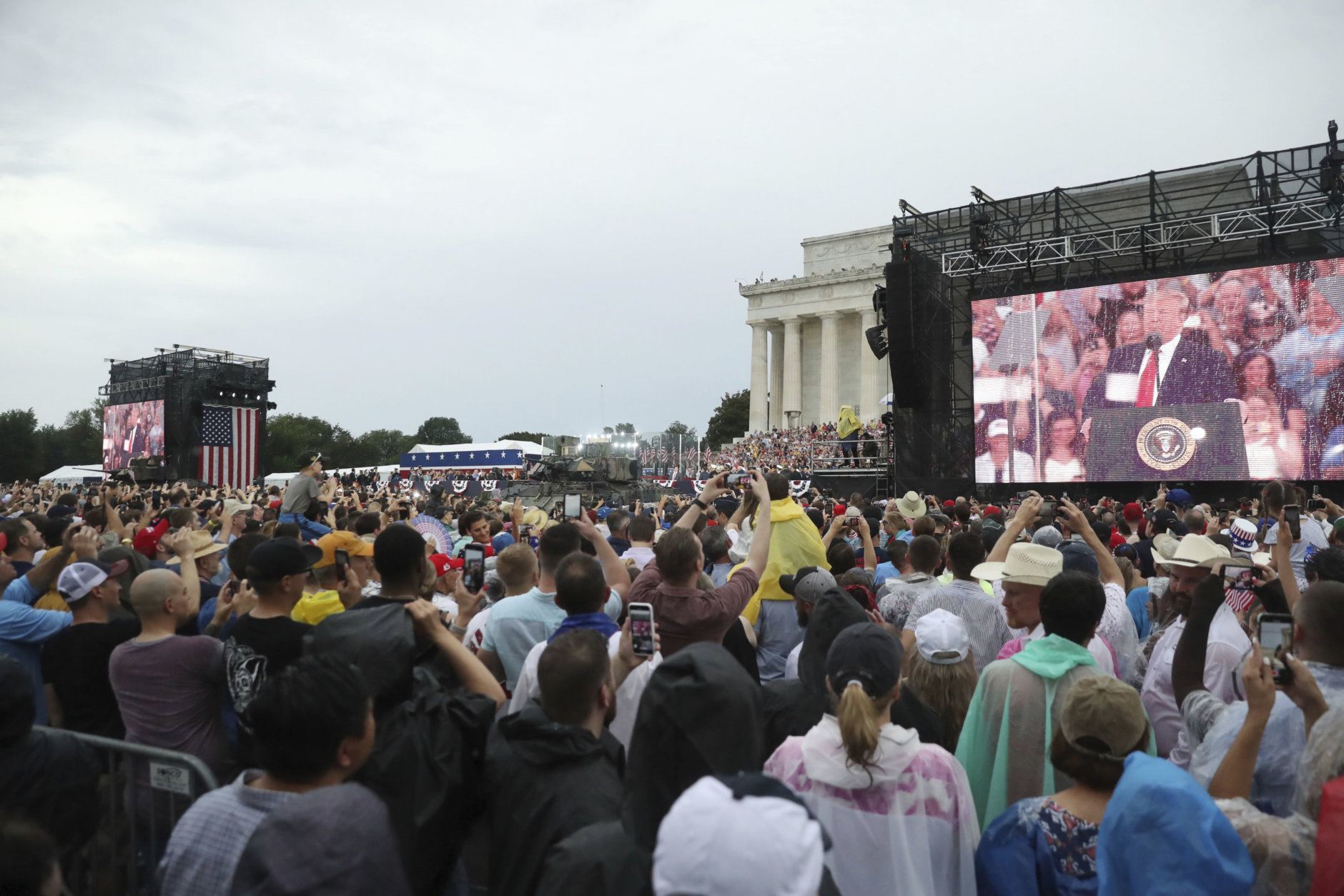President Donald Trump is seen on a large screen speaking during an Independence Day celebration in front of the Lincoln Memorial in Washington, Thursday, July 4, 2019. (AP Photo/Andrew Harnik)
