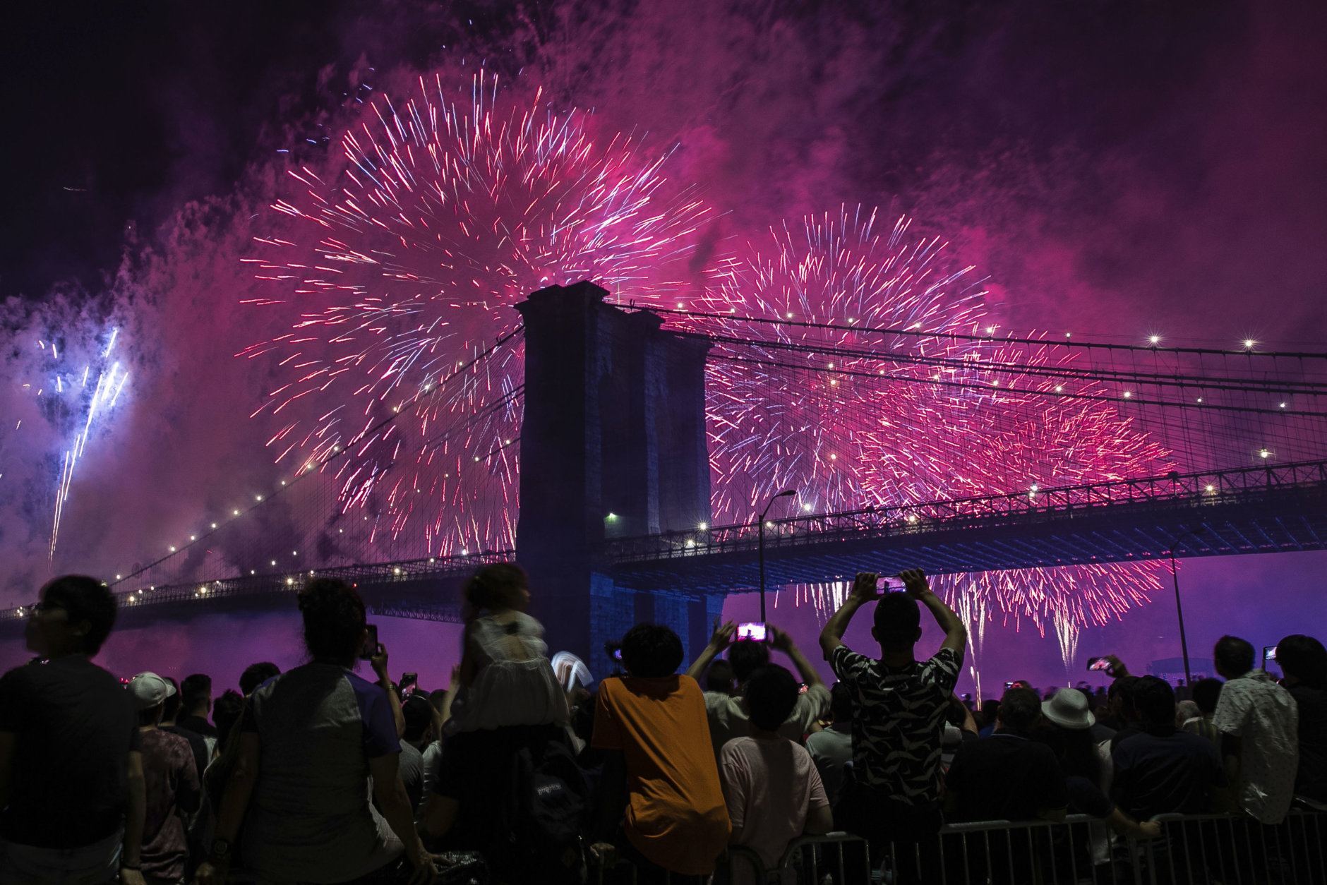 People on the east side of Manhattan watch a fireworks display, part of Independence Day festivities, Thursday, July 4, 2019, in New York. (AP Photo/Jeenah Moon)